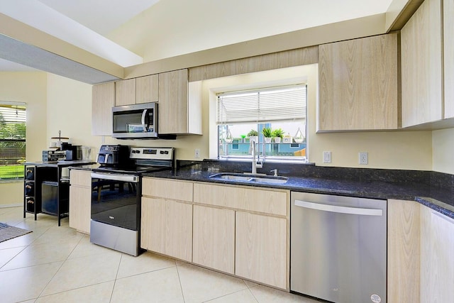 2282 NE Marlberry Ln, Jensen Beach, FL 34957 - kitchen with appliances with stainless steel finishes, light brown cabinetry, dark stone countertops, and light tile patterned floors