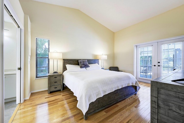 2282 NE Marlberry Ln, Jensen Beach, FL 34957 - bedroom featuring lofted ceiling, french doors, light wood finished floors, and access to outside