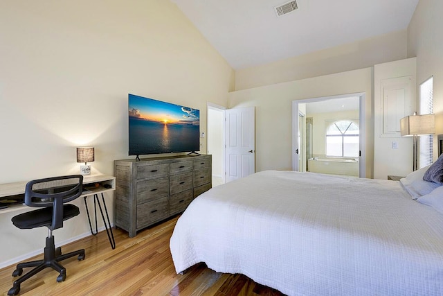 2282 NE Marlberry Ln, Jensen Beach, FL 34957 - bedroom featuring wood finished floors, high vaulted ceiling, and an office area