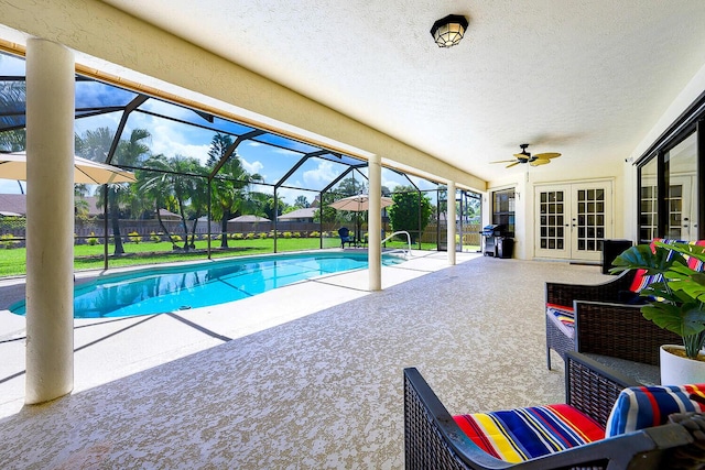 2282 NE Marlberry Ln, Jensen Beach, FL 34957 - view of swimming pool featuring french doors, a patio area, a lawn, outdoor lounge area, and a ceiling fan