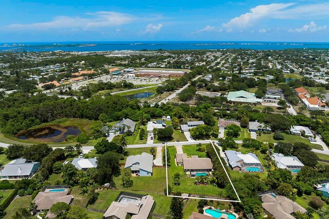 2282 NE Marlberry Ln, Jensen Beach, FL 34957 - back of house with a patio area, a yard, roof with shingles, an outdoor pool, and stucco siding