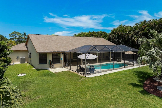 2282 NE Marlberry Ln, Jensen Beach, FL 34957 - back of house with a patio area, a yard, roof with shingles, an outdoor pool, and stucco siding