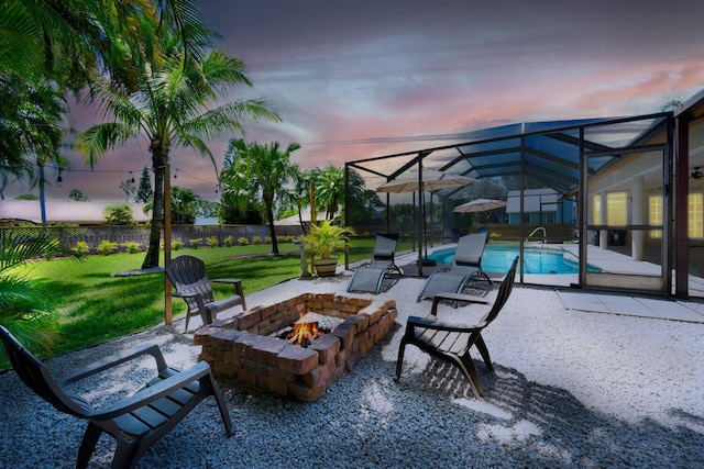 2282 NE Marlberry Ln, Jensen Beach, FL 34957 - patio terrace at dusk with an outdoor fire pit, a patio, and a lanai