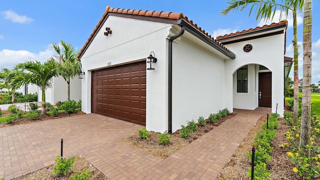203 SE Via Sangro, Port Saint Lucie, FL 34952 - garage featuring decorative driveway