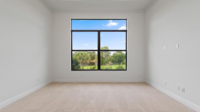203 SE Via Sangro, Port Saint Lucie, FL 34952 - unfurnished room with plenty of natural light and light carpet