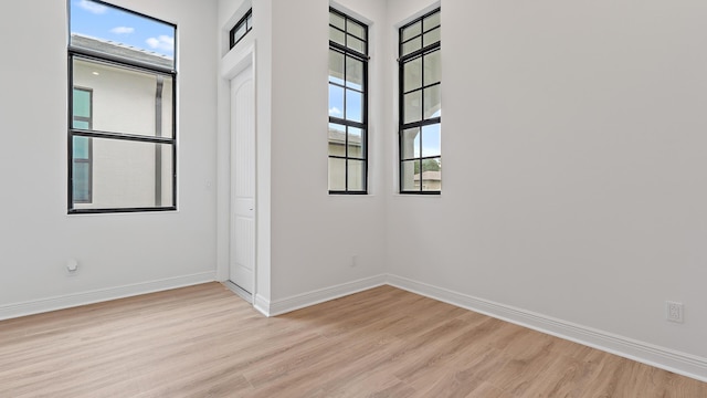 203 SE Via Sangro, Port Saint Lucie, FL 34952 - empty room featuring light wood-type flooring and baseboards