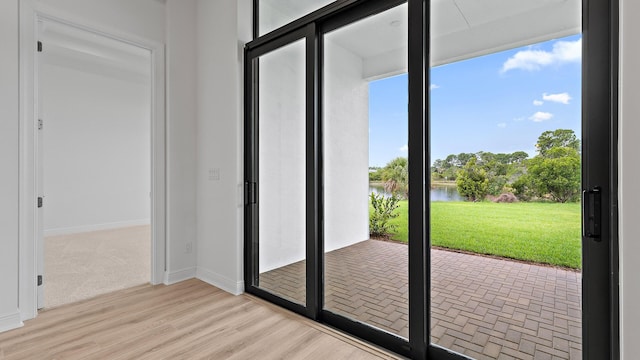203 SE Via Sangro, Port Saint Lucie, FL 34952 - doorway with a water view and light wood finished floors