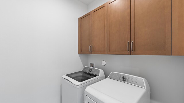 203 SE Via Sangro, Port Saint Lucie, FL 34952 - washroom featuring cabinet space and washing machine and clothes dryer