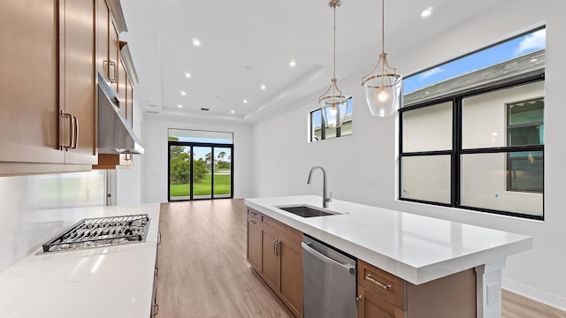 203 SE Via Sangro, Port Saint Lucie, FL 34952 - kitchen featuring appliances with stainless steel finishes, light wood-style flooring, a center island with sink, open floor plan, and recessed lighting