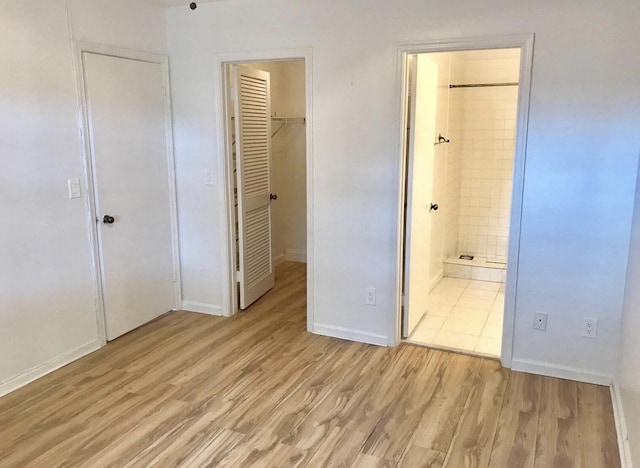 3501 NW 94th Ave Unit 1A, Sunrise, FL 33351 - unfurnished bedroom featuring a closet, light wood finished floors, a walk in closet, and ensuite bath