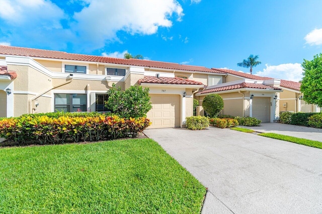 767 Windermere Way Unit 767, Palm Beach Gardens, FL 33418 - view of front of house featuring concrete driveway, stucco siding, a tiled roof, a front lawn, and a garage