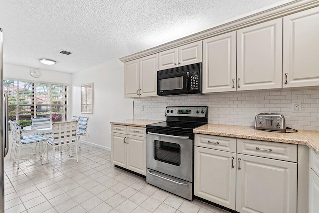 767 Windermere Way Unit 767, Palm Beach Gardens, FL 33418 - kitchen featuring stainless steel range with electric stovetop, black microwave, backsplash, light tile patterned floors, and a textured ceiling