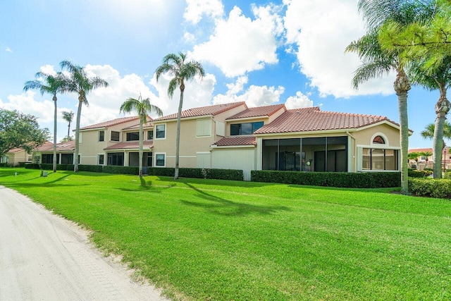 767 Windermere Way Unit 767, Palm Beach Gardens, FL 33418 - back of property with a tiled roof, a lawn, a sunroom, and stucco siding