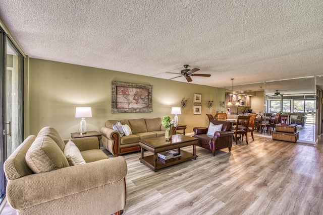 11186 Green Lake Dr Unit 202, Boynton Beach, FL 33437 - living room featuring ceiling fan, a textured ceiling, and light wood finished floors
