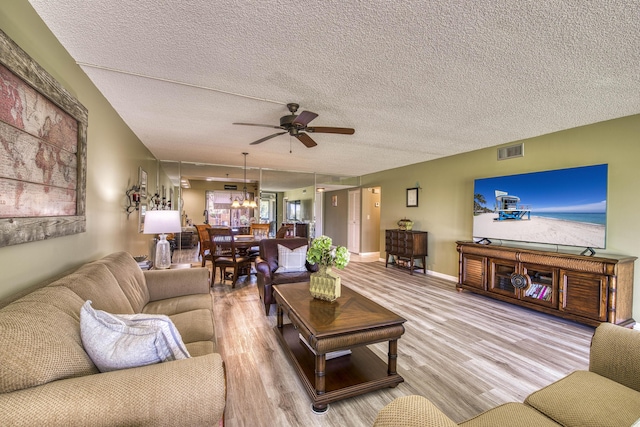 11186 Green Lake Dr Unit 202, Boynton Beach, FL 33437 - living room featuring ceiling fan, light wood finished floors, and a textured ceiling