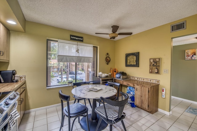 11186 Green Lake Dr Unit 202, Boynton Beach, FL 33437 - dining area with a ceiling fan, a textured ceiling, and light tile patterned floors
