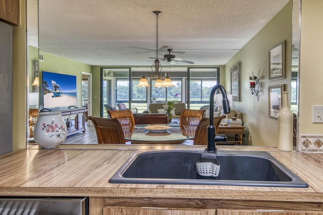 11186 Green Lake Dr Unit 202, Boynton Beach, FL 33437 - kitchen featuring a ceiling fan, a textured ceiling, stainless steel dishwasher, and wood finished floors