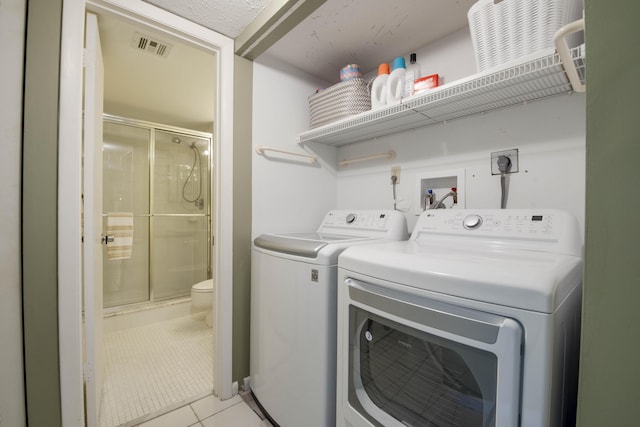 11186 Green Lake Dr Unit 202, Boynton Beach, FL 33437 - washroom with washer and dryer and light tile patterned flooring