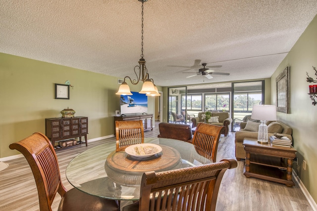 11186 Green Lake Dr Unit 202, Boynton Beach, FL 33437 - dining area featuring light wood finished floors, a textured ceiling, and ceiling fan