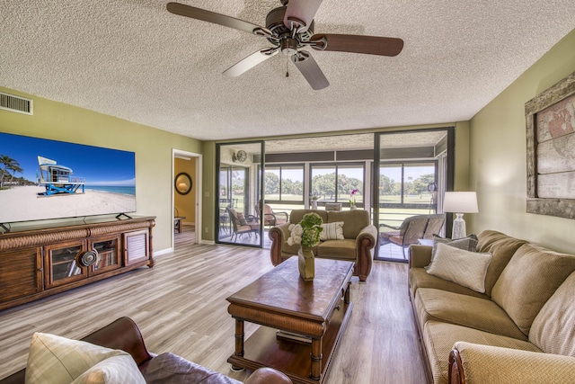 11186 Green Lake Dr Unit 202, Boynton Beach, FL 33437 - living area featuring a textured ceiling, wood finished floors, and a ceiling fan