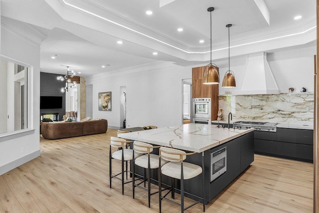 11533 Manatee Ter Unit 11533, Lake Worth, FL 33449 - kitchen with custom exhaust hood, ornamental molding, stainless steel appliances, a large island, and a raised ceiling