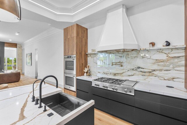 11533 Manatee Ter Unit 11533, Lake Worth, FL 33449 - kitchen featuring stainless steel appliances, premium range hood, ornamental molding, dark cabinets, and modern cabinets