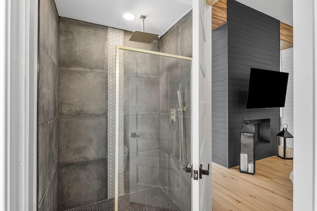 11533 Manatee Ter Unit 11533, Lake Worth, FL 33449 - bathroom featuring wood finished floors, a stall shower, and a fireplace