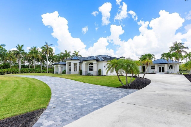 11533 Manatee Ter Unit 11533, Lake Worth, FL 33449 - view of front facade with curved driveway, a standing seam roof, a metal roof, and stucco siding