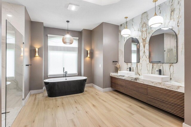 11533 Manatee Ter Unit 11533, Lake Worth, FL 33449 - bathroom featuring wood finished floors, double vanity, a freestanding tub, and a marble finish shower