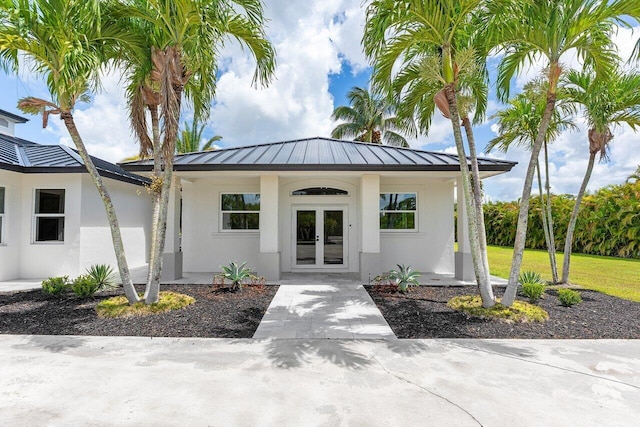 11533 Manatee Ter Unit 11533, Lake Worth, FL 33449 - entrance to property with french doors, a standing seam roof, stucco siding, and a metal roof