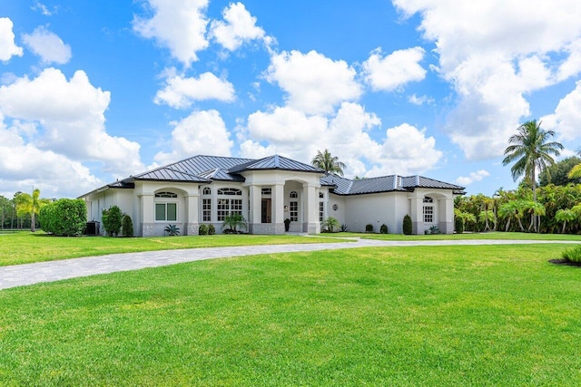 11533 Manatee Ter Unit 11533, Lake Worth, FL 33449 - view of front of home featuring a standing seam roof, stucco siding, curved driveway, and a front lawn