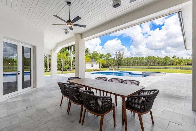 11533 Manatee Ter Unit 11533, Lake Worth, FL 33449 - view of patio with a ceiling fan, french doors, a pool with connected hot tub, and outdoor dining space