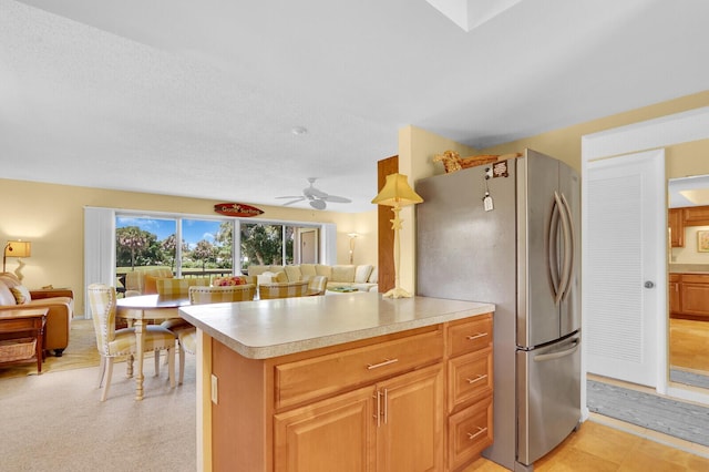 18429 SE Wood Haven Ln Unit G, Jupiter, FL 33469 - kitchen featuring freestanding refrigerator, light countertops, ceiling fan, and open floor plan