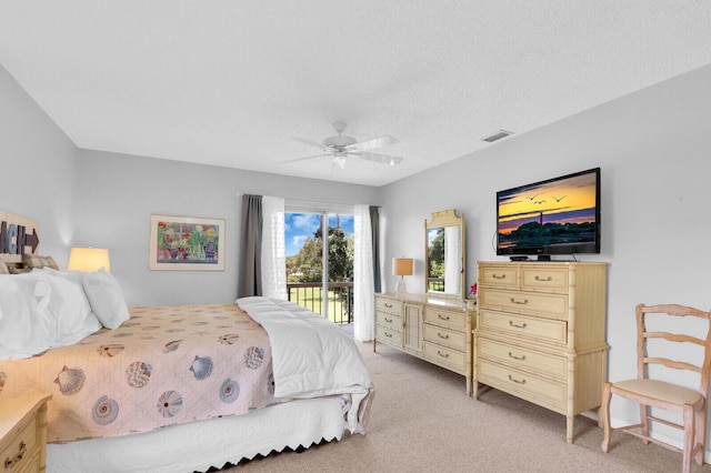18429 SE Wood Haven Ln Unit G, Jupiter, FL 33469 - bedroom with access to exterior, light carpet, and ceiling fan