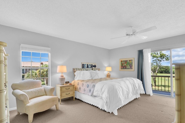 18429 SE Wood Haven Ln Unit G, Jupiter, FL 33469 - bedroom featuring access to exterior, carpet flooring, a textured ceiling, and a ceiling fan