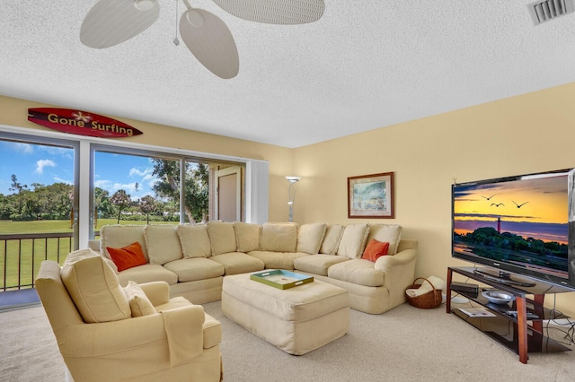 18429 SE Wood Haven Ln Unit G, Jupiter, FL 33469 - carpeted living room with a textured ceiling and ceiling fan