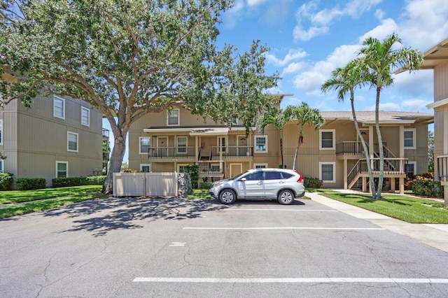 18429 SE Wood Haven Ln Unit G, Jupiter, FL 33469 - view of front facade with uncovered parking and stairs