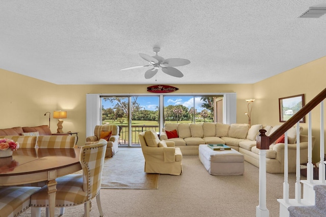 18429 SE Wood Haven Ln Unit G, Jupiter, FL 33469 - living room with plenty of natural light, carpet, a textured ceiling, a ceiling fan, and stairway