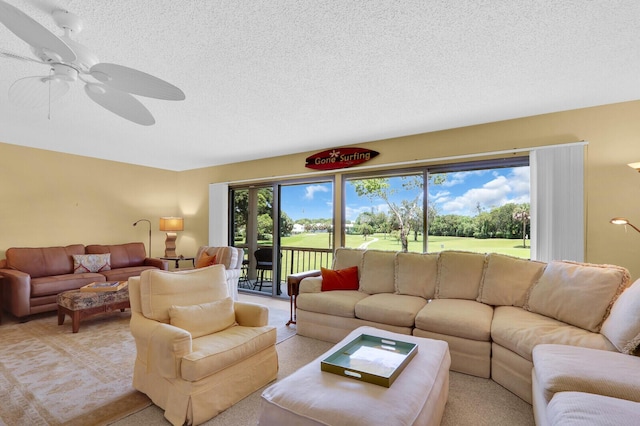 18429 SE Wood Haven Ln Unit G, Jupiter, FL 33469 - living room with a textured ceiling, light colored carpet, ceiling fan, and view of golf course