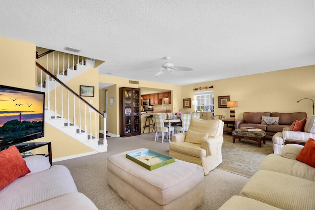 18429 SE Wood Haven Ln Unit G, Jupiter, FL 33469 - living area featuring stairs, carpet flooring, a ceiling fan, and a textured ceiling