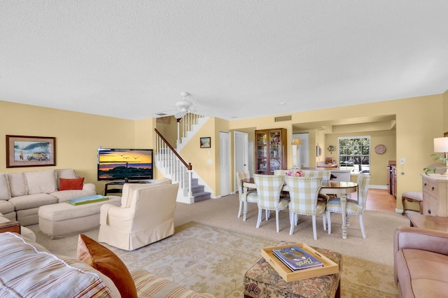 18429 SE Wood Haven Ln Unit G, Jupiter, FL 33469 - living room with stairs, light carpet, and a textured ceiling