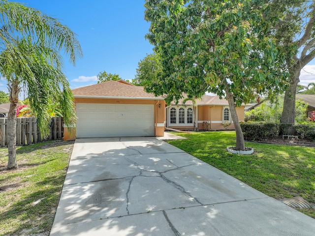 790 SE Ablett Ln, Port Saint Lucie, FL 34984 - view of front facade with concrete driveway, an attached garage, and stucco siding