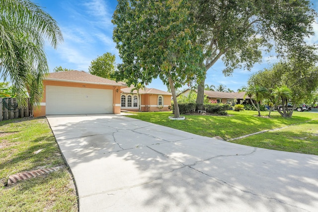 790 SE Ablett Ln, Port Saint Lucie, FL 34984 - ranch-style home featuring stucco siding, an attached garage, concrete driveway, and a front yard