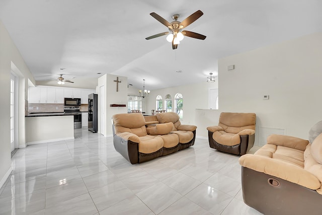 790 SE Ablett Ln, Port Saint Lucie, FL 34984 - living room featuring a ceiling fan, light tile patterned floors, a chandelier, and lofted ceiling