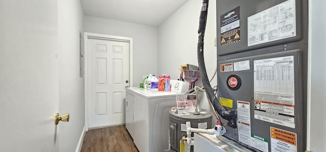 716 NW 16th St, Belle Glade, FL 33430 - washroom with heating unit, separate washer and dryer, wood finished floors, and water heater