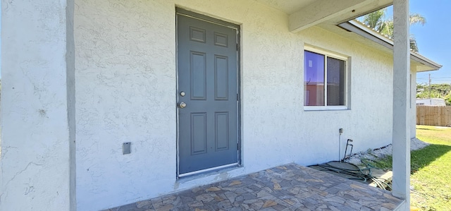716 NW 16th St, Belle Glade, FL 33430 - property entrance featuring stucco siding