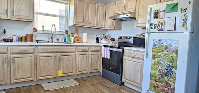 716 NW 16th St, Belle Glade, FL 33430 - kitchen featuring freestanding refrigerator, electric stove, under cabinet range hood, and light countertops