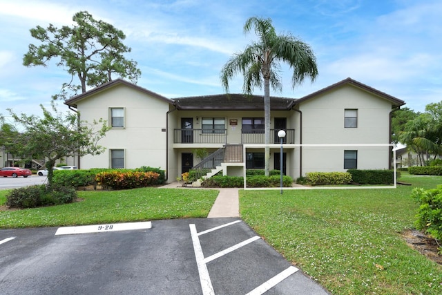 7626 Tahiti Ln Unit 104, Lake Worth, FL 33467 - view of building exterior featuring uncovered parking and stairway