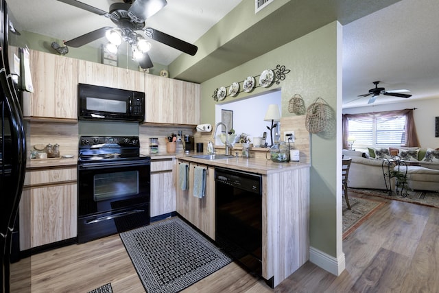 7626 Tahiti Ln Unit 104, Lake Worth, FL 33467 - kitchen with black appliances, a ceiling fan, light brown cabinets, light countertops, and open floor plan