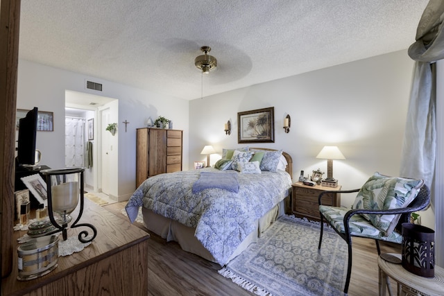 7626 Tahiti Ln Unit 104, Lake Worth, FL 33467 - bedroom featuring a textured ceiling, ceiling fan, and wood finished floors